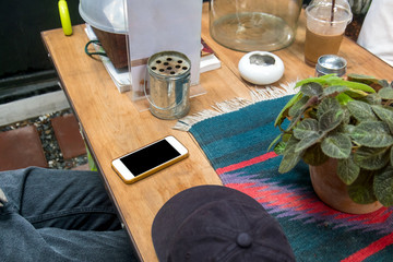 Smartphone on the wood table in cafe