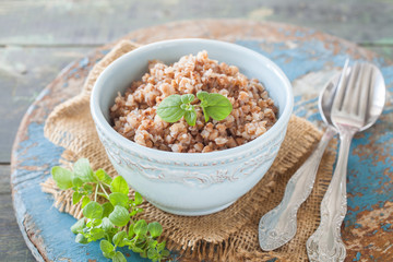 buckwheat cereal in a bowl on a table, selective focus