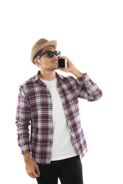 Handsome hipster young man in hat and sunglasses standing and ta