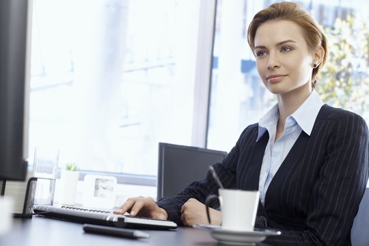 Attractive businesswoman sitting at desk
