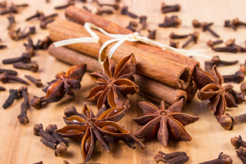 Obraz na płótnie Canvas Star anise, cinnamon sticks and cloves on wooden table, seasoning for cooking