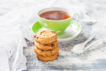 cookies and tea in a cup on a concrete background, selective focus