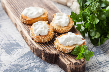 cottage cheese cheese and greens sandwiches on a board, selective focus
