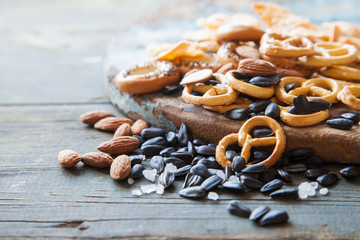 sunflower seeds, nuts and crackers on a table, selective focus