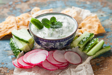 sauce Tzatziki and vegetables on a table, selective focus