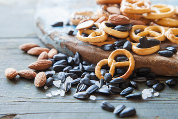 sunflower seeds, nuts and crackers on a table, selective focus