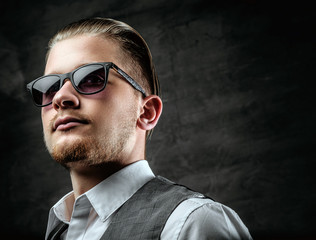 Fototapeta premium A man in sunglasses dressed in sleeveless shirt.
