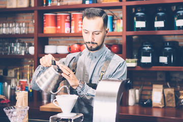 Bartender pouring water in coffee filter