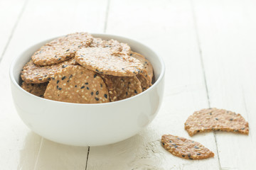 Cookies in white ceramic dish on wooden table