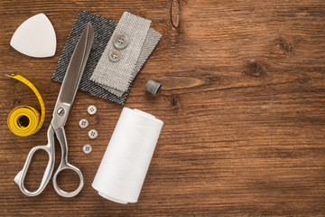  Sewing accessories on wooden background 