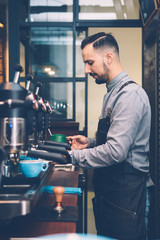 Coffeemaker frothing milk on pitcher
