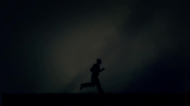 Man Running Under a Lightning Storm and Rain at Night - Loop