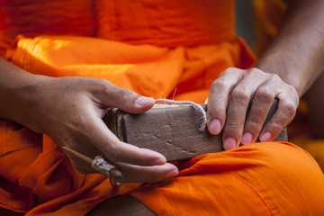 Asian monk hand with orange tunic read the future in Angkor Wat temple, Cambodia