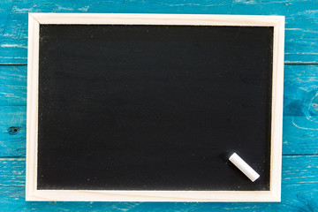 Wooden framed blank blackboard with a  chalk on wooden backgroun