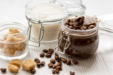 homemade coffe scrub in glass jar on wooden background
