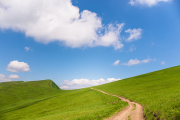idyllic landscape of green heels, blue sky in Carpathian mountains