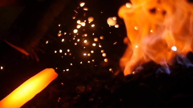 A blacksmith Making a Sword in His Forge With a Fire Sparks