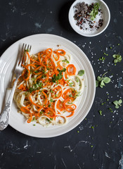 Pumpkin noodles spaghetti. Tasty vegetarian food. On a dark background, top view