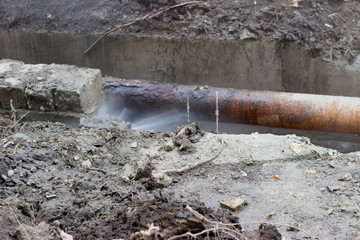  Broken old pipes of the heating system; water splashing