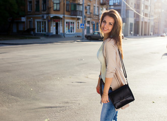 Fototapeta premium Portrait of beauty woman with perfect smile walking on the street and looking at camera
