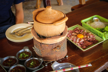 clay pot.Thai traditional spicy shabu shabu, dipping meat in boiled spicy soup