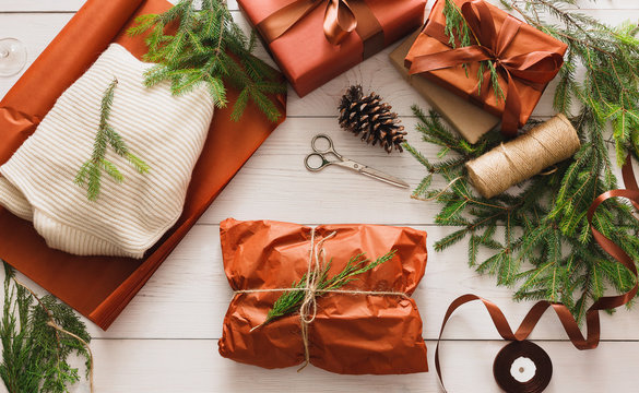 Wrapping christmas present gift on white wood background