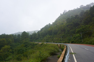 mountain view along the road, cloudy sky