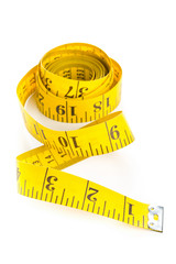 Yellow measure tape on white background