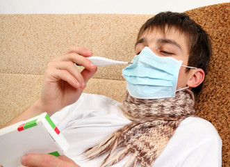 Sick Teenager with Thermometer