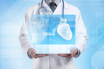 Cardiologist holding tablet. Projection of screen. Medicine and modern technology concept.
