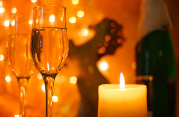 Style New Years Eve celebration background with horse an elegant arrangement with a clock counting down to midnight, flutes and bottle of champagne and party streamers with a candles.