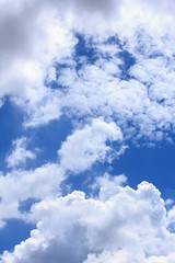 Blue sky background with white clouds and rain clouds. The vast blue sky and clouds sky on sunny day. White fluffy clouds in the blue sky.