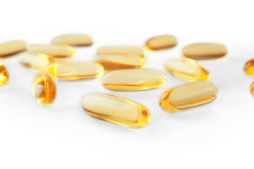 Cod liver oil capsules on white background