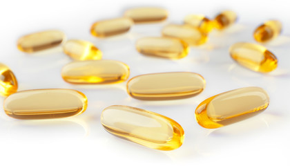 Cod liver oil capsules on white background
