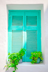 Fototapeta na wymiar Traditional colorful window in the narrow streets of Mykonos, Greece.