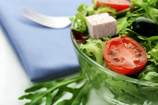 Bowl of fresh mixed salad leaves with tomatoes closeup