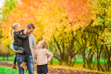 Fototapeta premium Family having fun on autumn day. Dad and kids enjoy fall