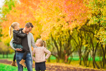 Family having fun on autumn day. Dad and kids enjoy fall