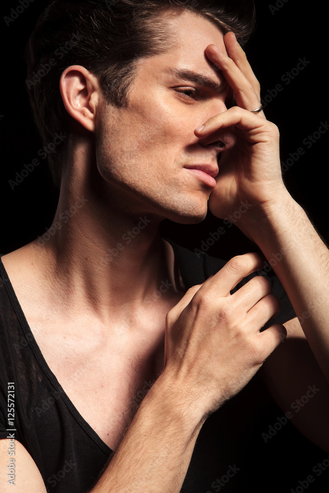 Poster closeup of a sad man with hands on his face