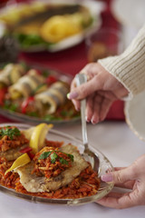 Taking greek style fish with silverware