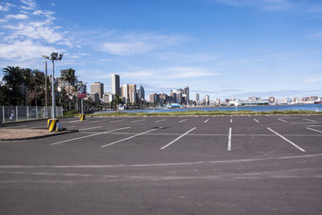 Empty Parking Lot Against City Skyline at Harbor