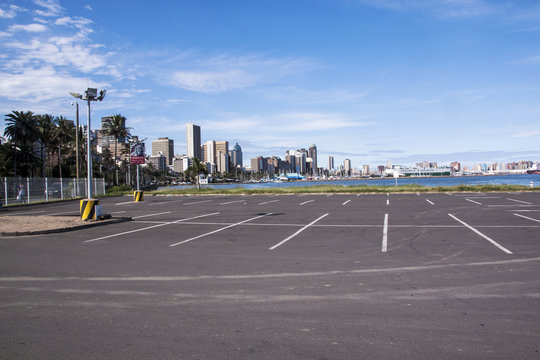 Empty Parking Lot Against City Skyline at Harbor