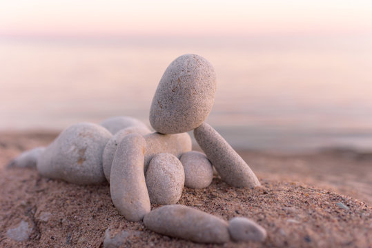 Figurine of pebbles on seashore