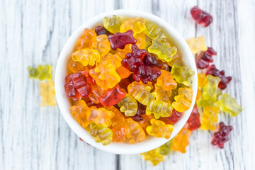 Wooden table with Gummy Bears (selective focus)