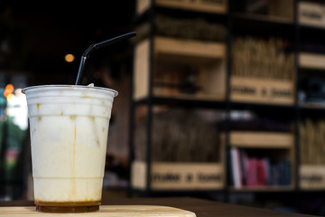 Ice coffee with milk on the wooden table