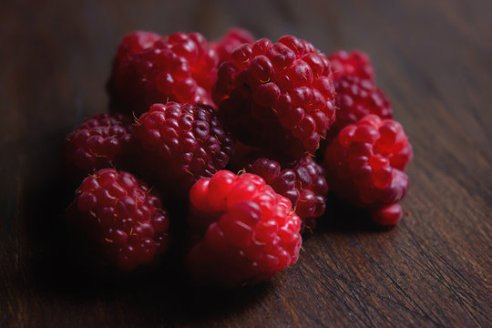 Raspberries on Wooden Table Close Up
