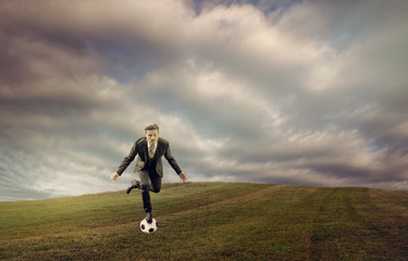 Businessman Balancing on Soccer Ball-Keep Balance Concept