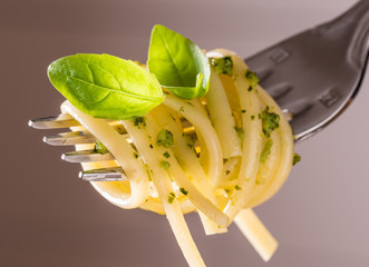 Pesto pasta.Fork with pesto spaghetti.