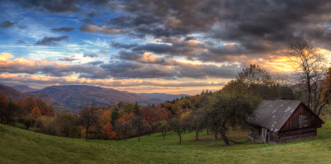 Autumn Sunset Landscape with Cloudy Sky and Colorful Trees