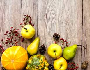 Stylish composition of vegetables, fruits, autumn berries. Top view on wooden background. Autumn flat lay